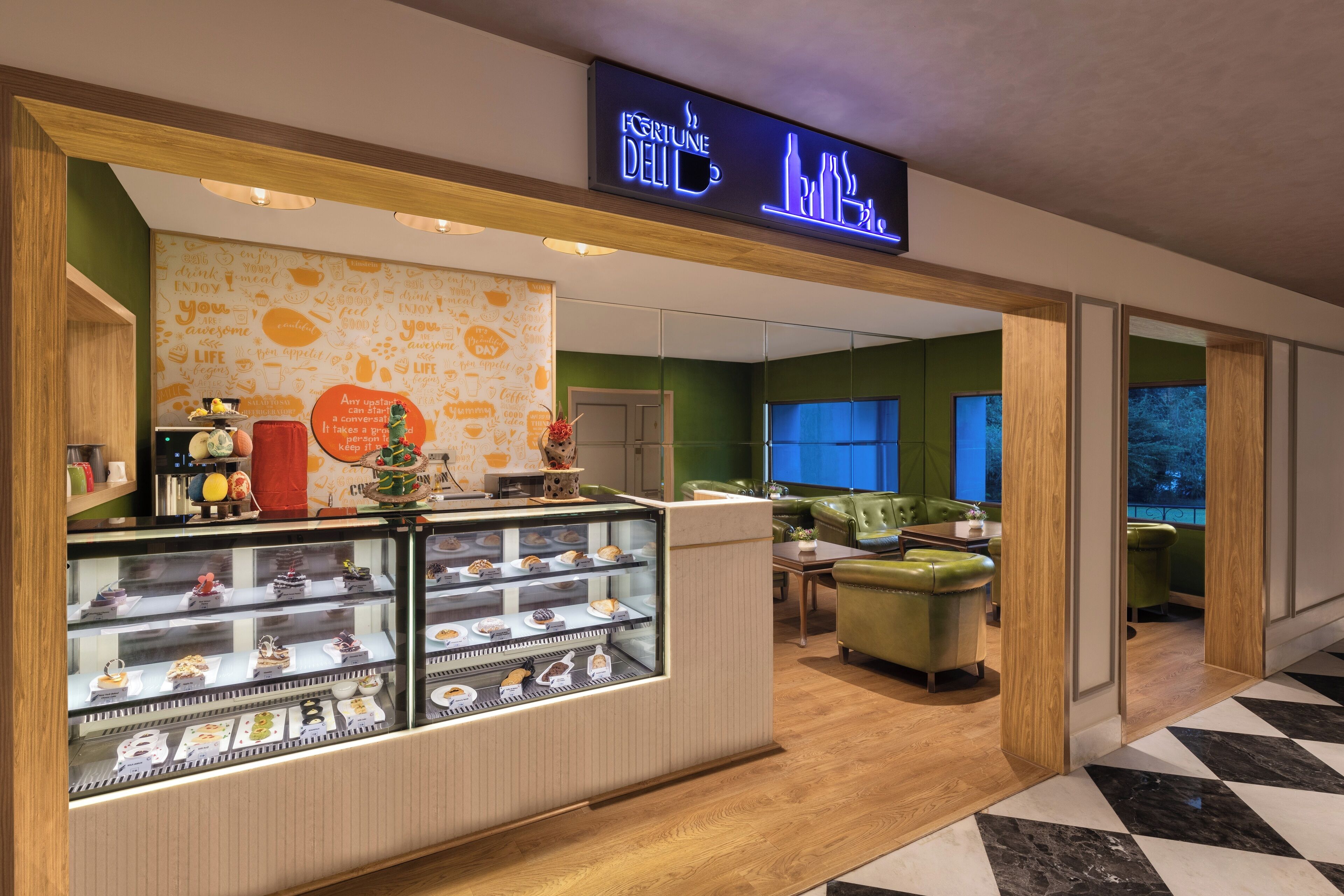 A bakery counter with a variety of pastries and a neon sign above.