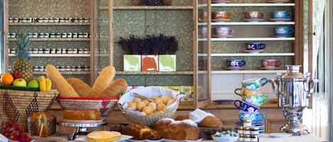 A kitchen counter with bread, pastries, and a variety of kitchen utensils.
