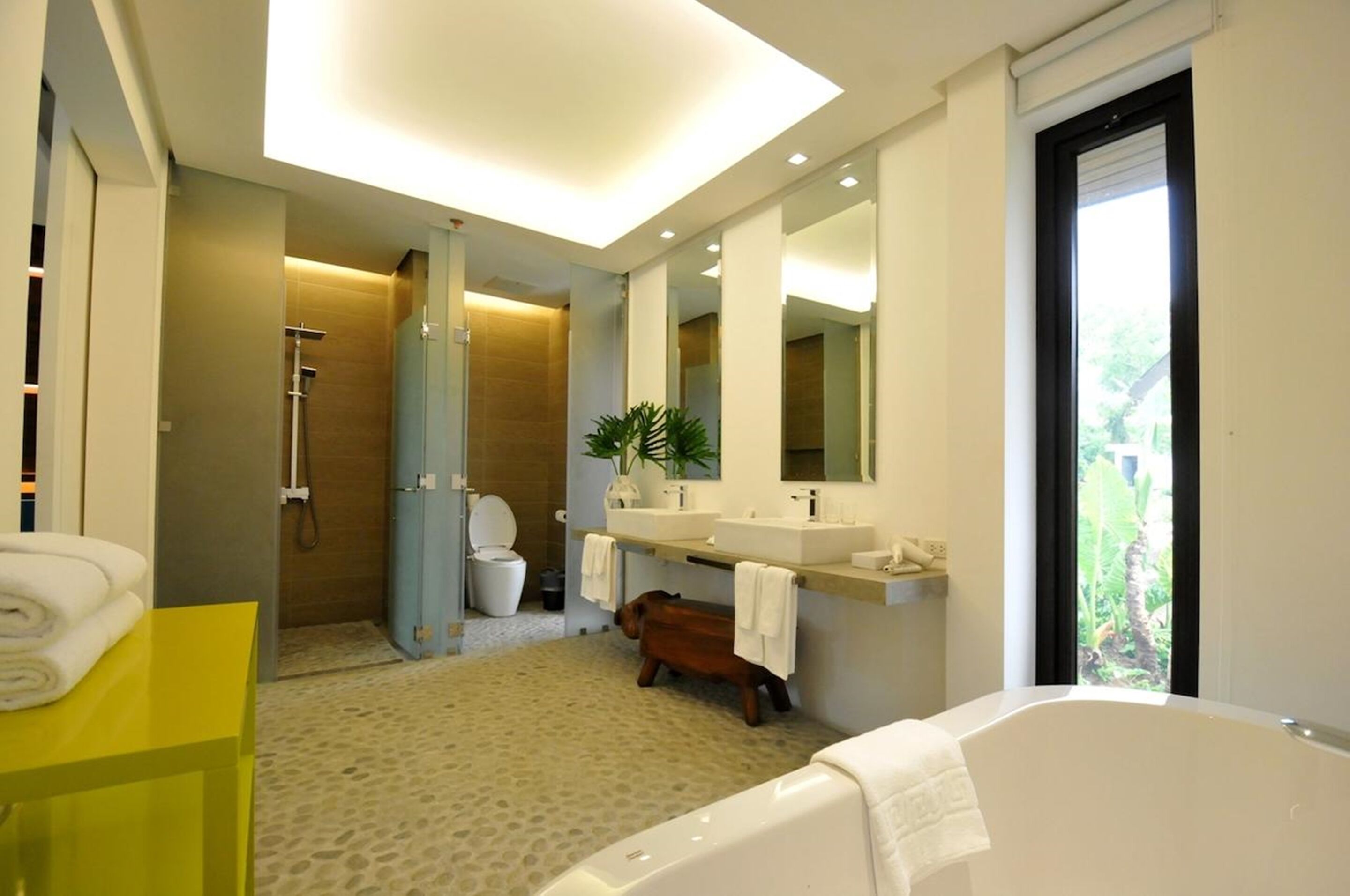 one-bedroom suite | bathroom | combined shower/bathtub, rainfall showerhead, free toiletries