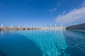 A clear blue swimming pool with a modern design, surrounded by a concrete deck and a metal railing. - Hotel AF Valle Orotava (Puerto de la Cruz)