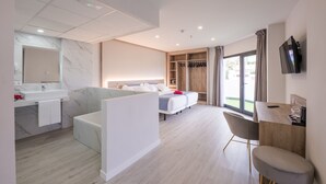 A modern hotel room with a bathroom, a sitting area, a bed, a TV, and a balcony. - Hotel AF Valle Orotava (Puerto de la Cruz)