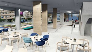 A modern cafe with round tables and chairs, large windows, and a view of the cityscape. - Hotel AF Valle Orotava (Puerto de la Cruz)