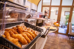 A buffet with various baked goods including croissants and pastries. - B&B Galileo 2000 (Florence)