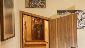 A wooden staircase leading to a room with a wooden door. - Escambo Hostel (Sao Paulo)