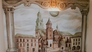 A mural of a historical cityscape with buildings and a tower. - Aparthotel Grodzka 21 (Kraków)