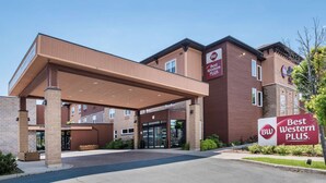 A Best Western Plus hotel entrance with a covered walkway, brick facade, and signage. - Best Western Plus Bathurst Hotel & Suites (Bathurst)