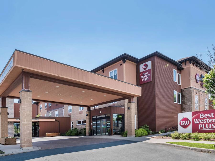 A Best Western Plus hotel entrance with a covered walkway, brick facade, and signage.