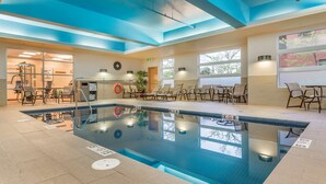 An indoor swimming pool with clear water, a lifeguard chair, and a changing room in the background. - Best Western Plus Bathurst Hotel & Suites (Bathurst)