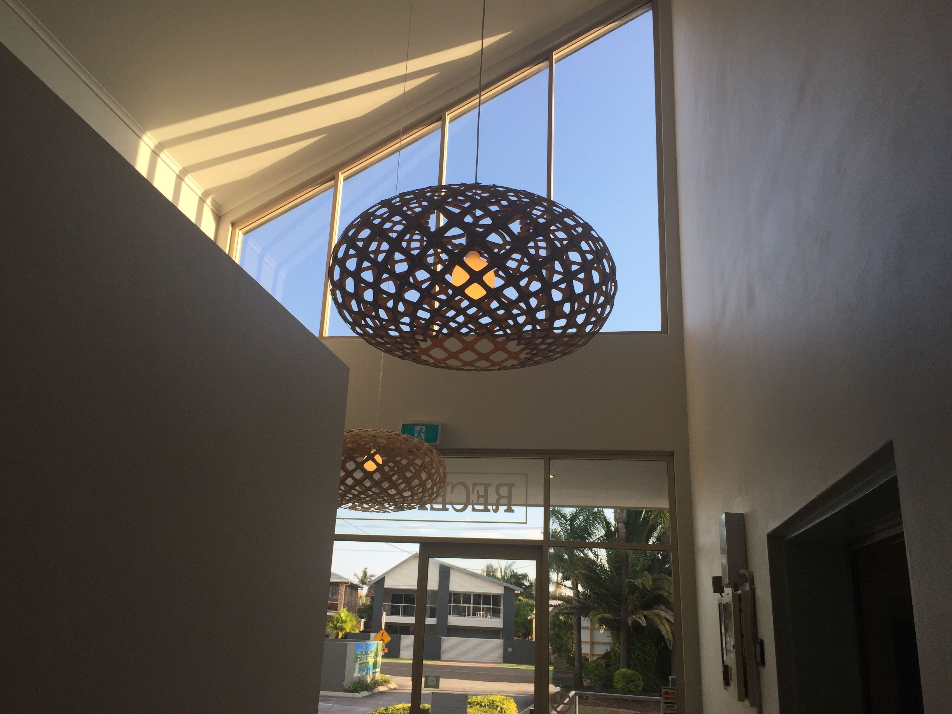A building entrance with large windows and a spherical decorative light fixture.