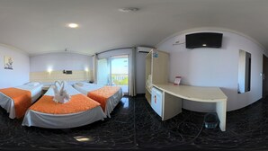 A hotel room with two beds, a desk, a TV, and a window with a view. - Hotel Três Fronteiras (Foz do Iguaçu)