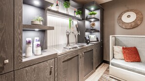 A modern kitchen with built-in appliances, a coffee machine, and a wine bottle on the counter. - Homewood Suites by Hilton Charlotte Ballantyne, NC (Charlotte)