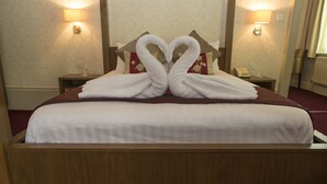 A hotel room with a bed, two nightstands, a lamp, and a telephone. - Crown Hotel Harrogate (Harrogate)