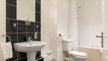 A modern bathroom with a white sink, toilet, and bathtub.