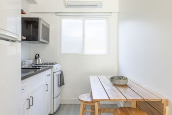 Deluxe Room, 2 Queen Beds, Kitchen, Pool View (Ground Floor) | Private kitchen | Fridge, microwave at Blue Sands Inn, A Kirkwood Collection Hotel