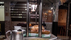 A buffet setup with various food items including sliced fruits, cheeses, and meats. - Pousada Caroline (Foz do Iguaçu)