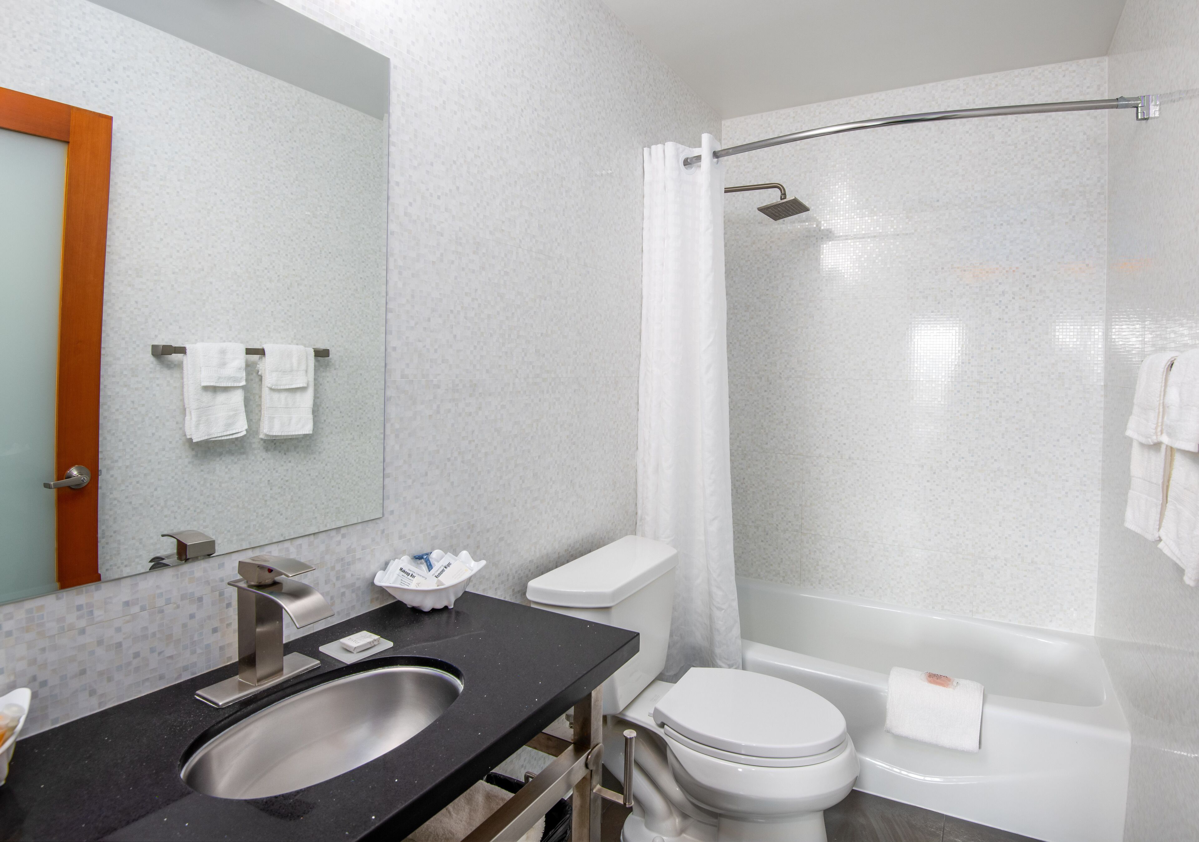 deep-soaking bathtub, rainfall showerhead, designer toiletries