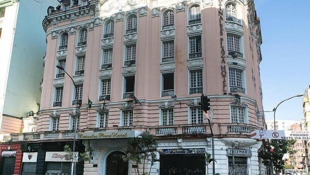 A historic building with a classical architectural style, featuring multiple windows and ornate detailing.
