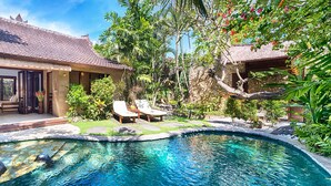 A house with a swimming pool, outdoor furniture, and lush greenery. - Villa Kubu, Seminyak (Seminyak)