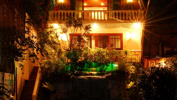 A house with a swimming pool, surrounded by lush greenery and illuminated by warm lights. - The Sitio Boracay Villas and Suites (Boracay Island)