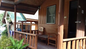 A wooden porch with a railing, a bench, and a door marked with the number 3. - Save Bungalows (Koh Tao)
