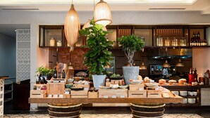 Una cocina bien iluminada con encimeras de madera, lámparas colgantes y una variedad de utensilios y electrodomésticos.