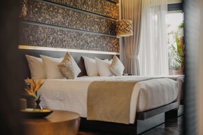 A modern bedroom with a large bed, a decorative wall, and a view of greenery outside. - Salinda Resort Phu Quoc Island (Phu Quoc)