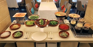 A semi-buffet breakfast setup with various dishes and condiments. - The Gaia Hotel Taipei (Taipei)