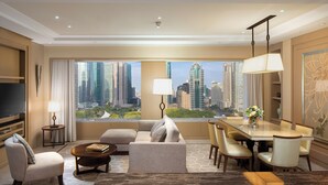 A modern hotel room with a city view, a flat-screen TV, a dining area, and a sofa. - IFC Residence (Shanghai)