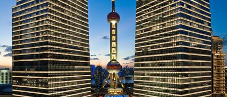 A high-rise building with a distinctive tower in the center, surrounded by other tall buildings.