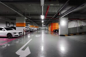 A multi-level parking garage with clearly marked parking spaces and directional arrows on the floor. - Shinchon Ever8 Serviced Residence (Seoul)