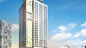 A high-rise building with multiple floors, featuring a prominent sign on the top. - Shinchon Ever8 Serviced Residence (Seoul)
