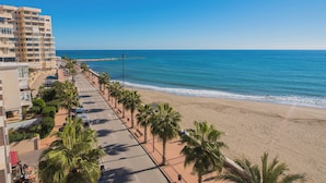 A beachfront hotel with a palm-lined promenade, ocean view, and a pier extending into the sea. - Apartamentos Vegasol Playa A.T. (Fuengirola)