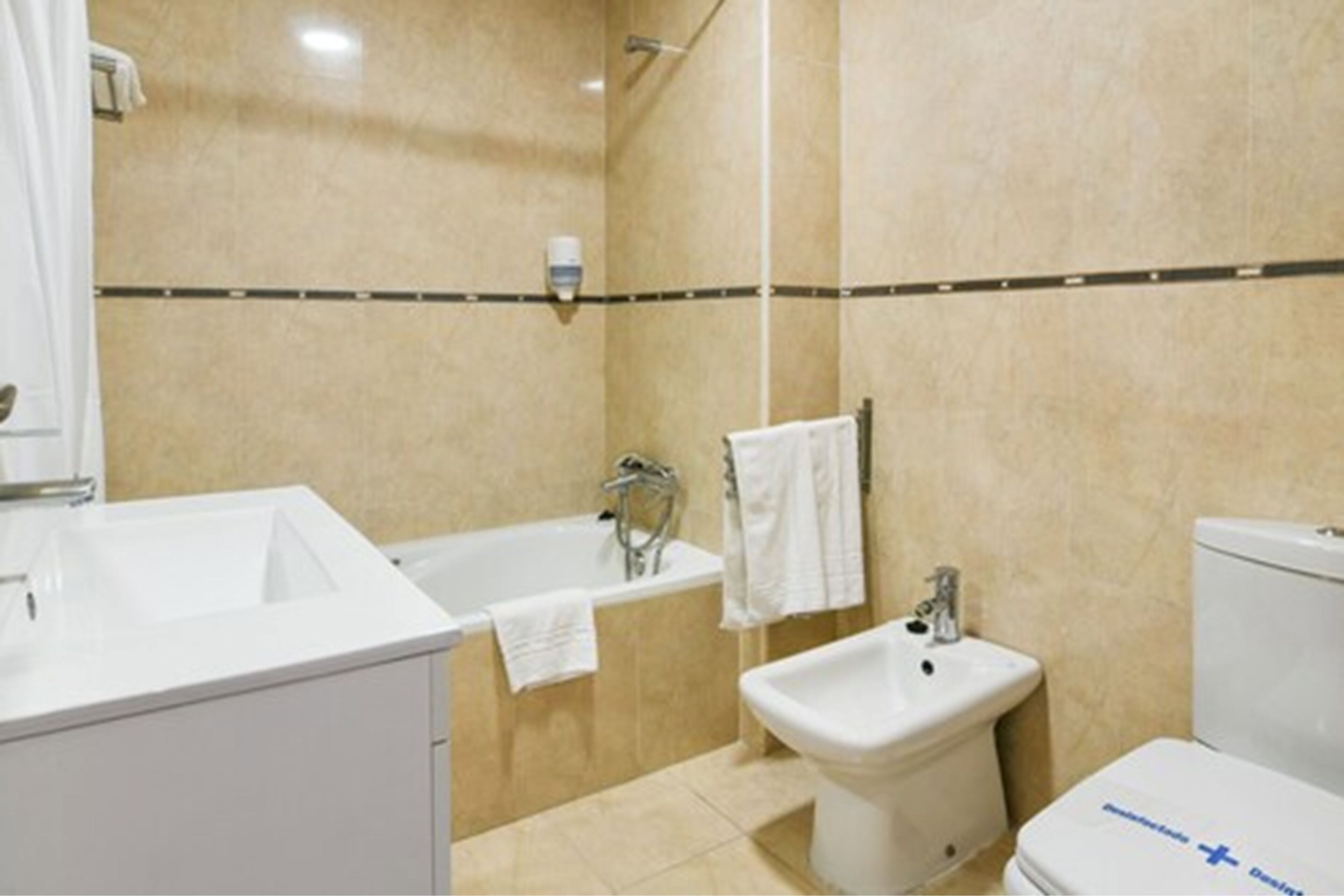 A bathroom with a bathtub, a sink, and a toilet.