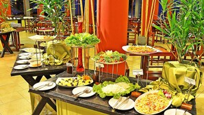A buffet setup with various dishes and a salad bar. - Club Koggala Village (Koggala)