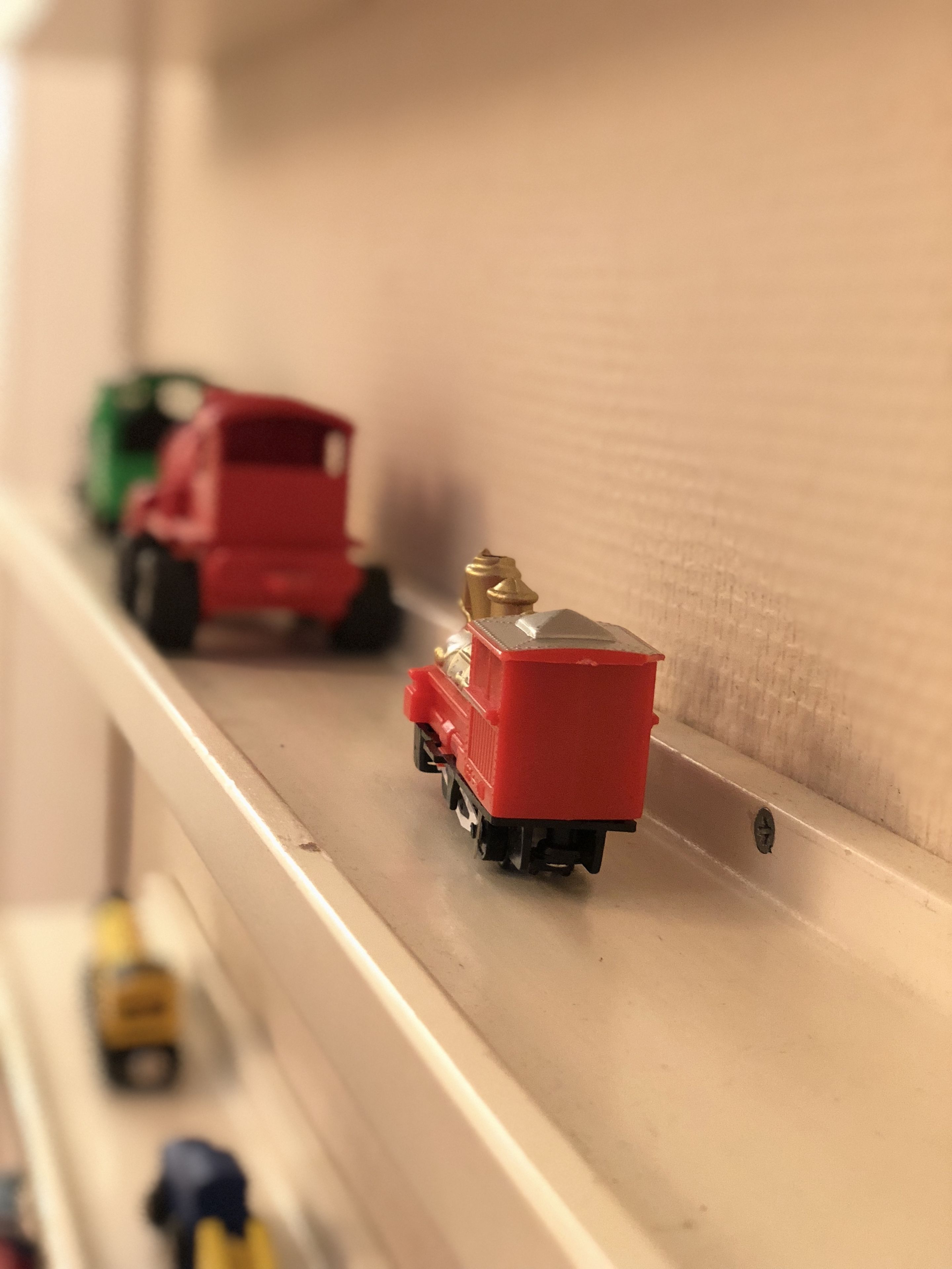A model train set with various vehicles on tracks.