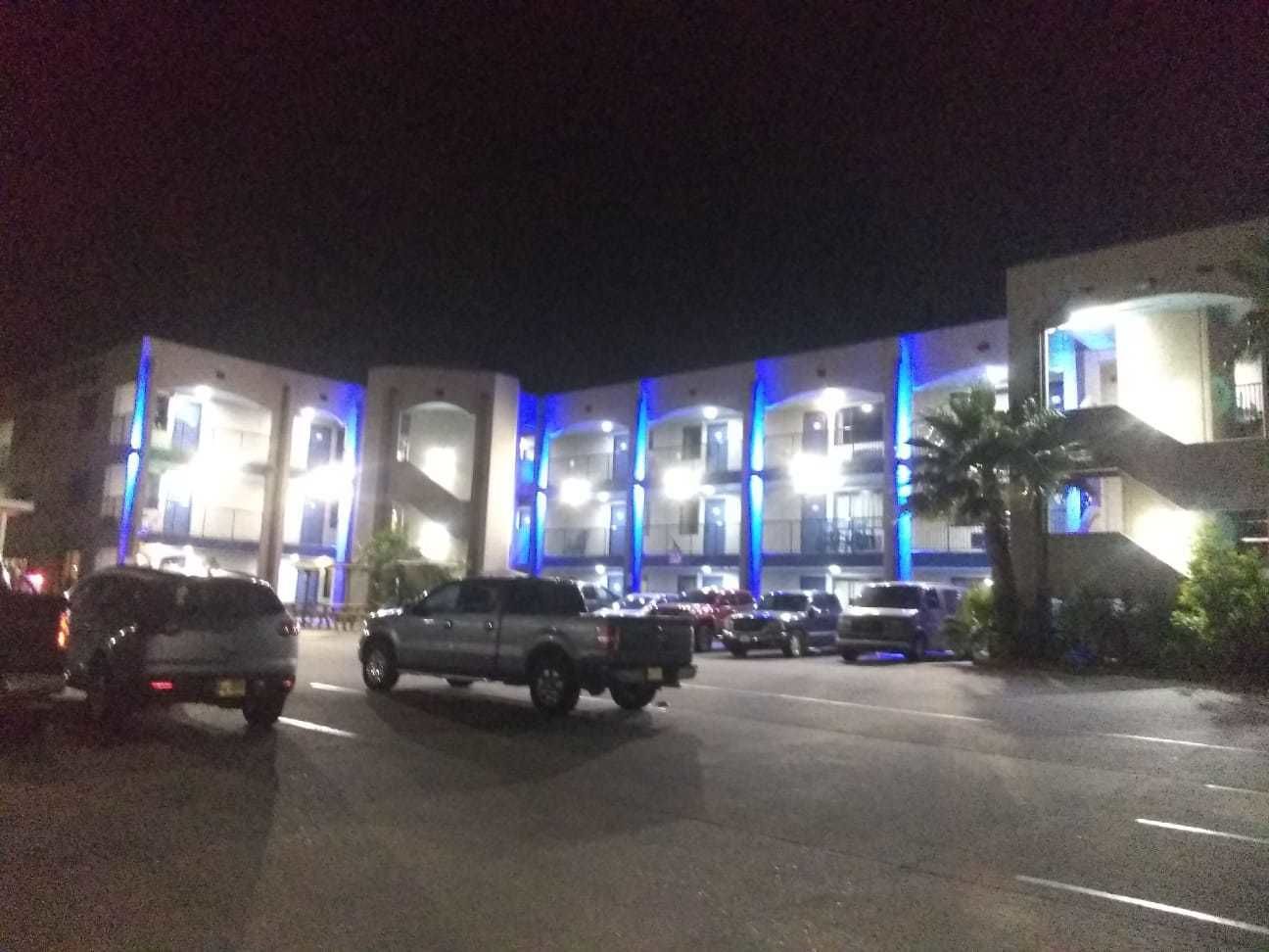A multi-story building with illuminated blue lighting.