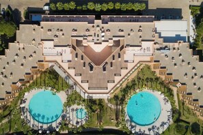 A hotel with a central courtyard, two swimming pools, and a symmetrical building layout. - Sao Rafael Suites (Albufeira)