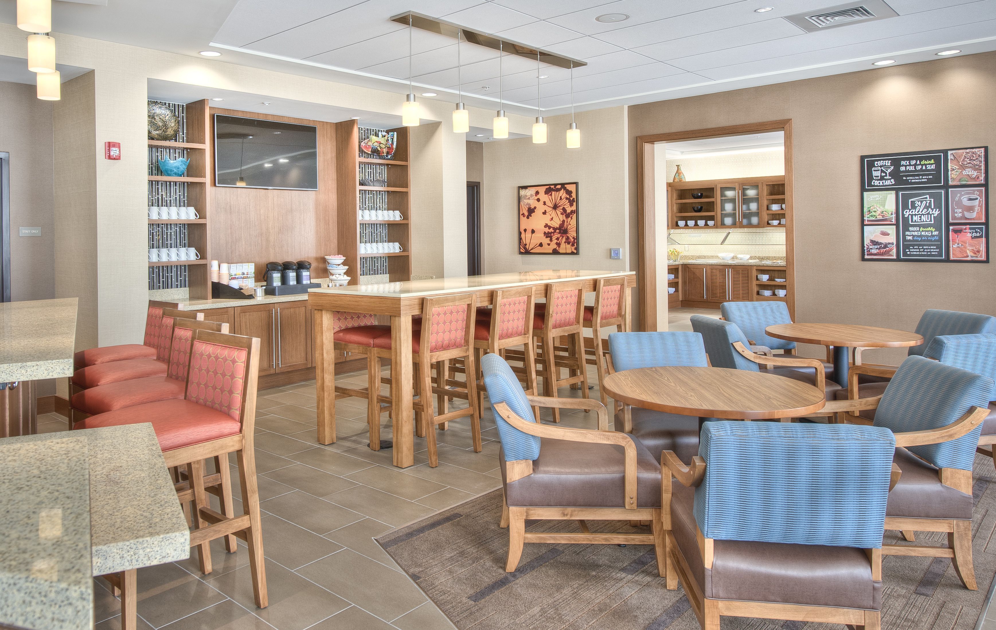 A modern cafe with wooden tables and chairs, a coffee bar, and a menu board.