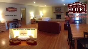 A living room area with a sofa, a dining table, and a separate queen bedroom. - Southampton Long Island Hotel (Southampton)