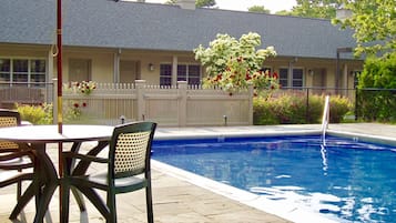 Relax by the pool surrounded by a tranquil waterfall and comfortable seating.