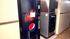 A vending machine with a Pepsi logo and an ice dispenser.