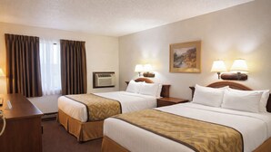 A hotel room with two beds, a desk, a telephone, and a painting on the wall.
