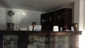 A reception desk with a sign indicating internet availability. - Kamala Phuyai Resort (Kamala)