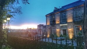 A stone building with a sign that reads "Hotel". - The Raeburn (Edinburgh)