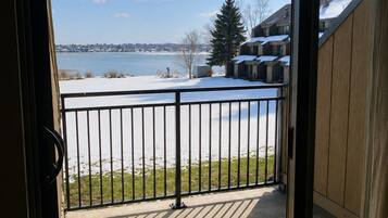 A balcony with a view of a lake and buildings.