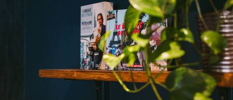 A shelf with books and a potted plant.