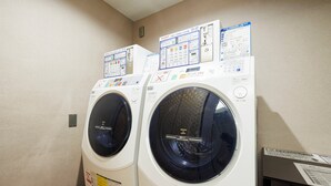 Two front-loading washing machines with control panels and safety instructions. - Holiday Inn Ana Sapporo Susukino by IHG (Sapporo)