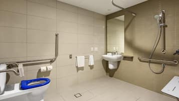 A modern bathroom with a toilet, sink, and shower.