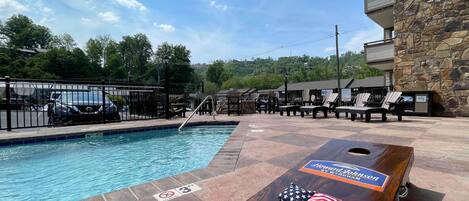 Seasonal outdoor pool, open 10:00 AM to 10:00 PM, pool loungers