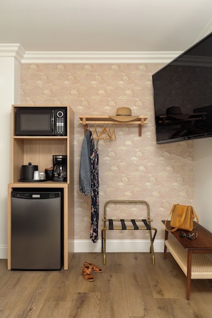 A compact kitchenette with a microwave, coffee maker, and refrigerator. - Solei House (Santa Barbara)